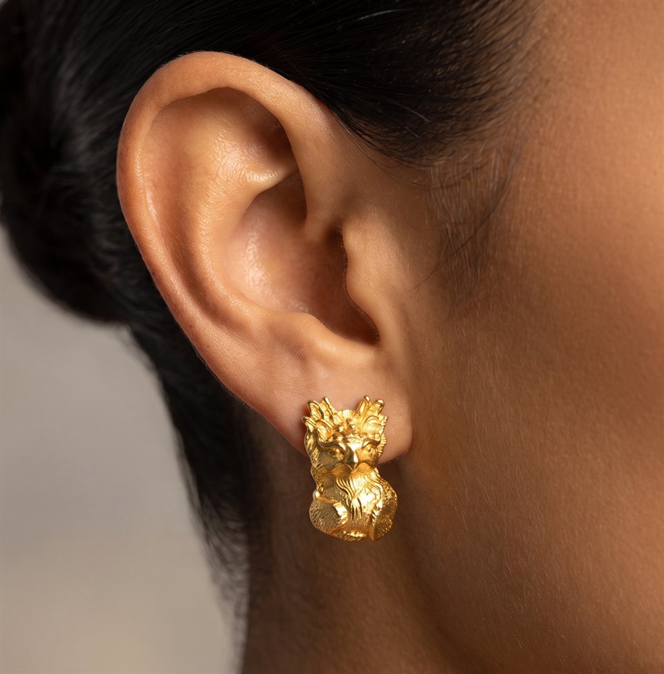 Textured gold harpy eagle stud earring, worn