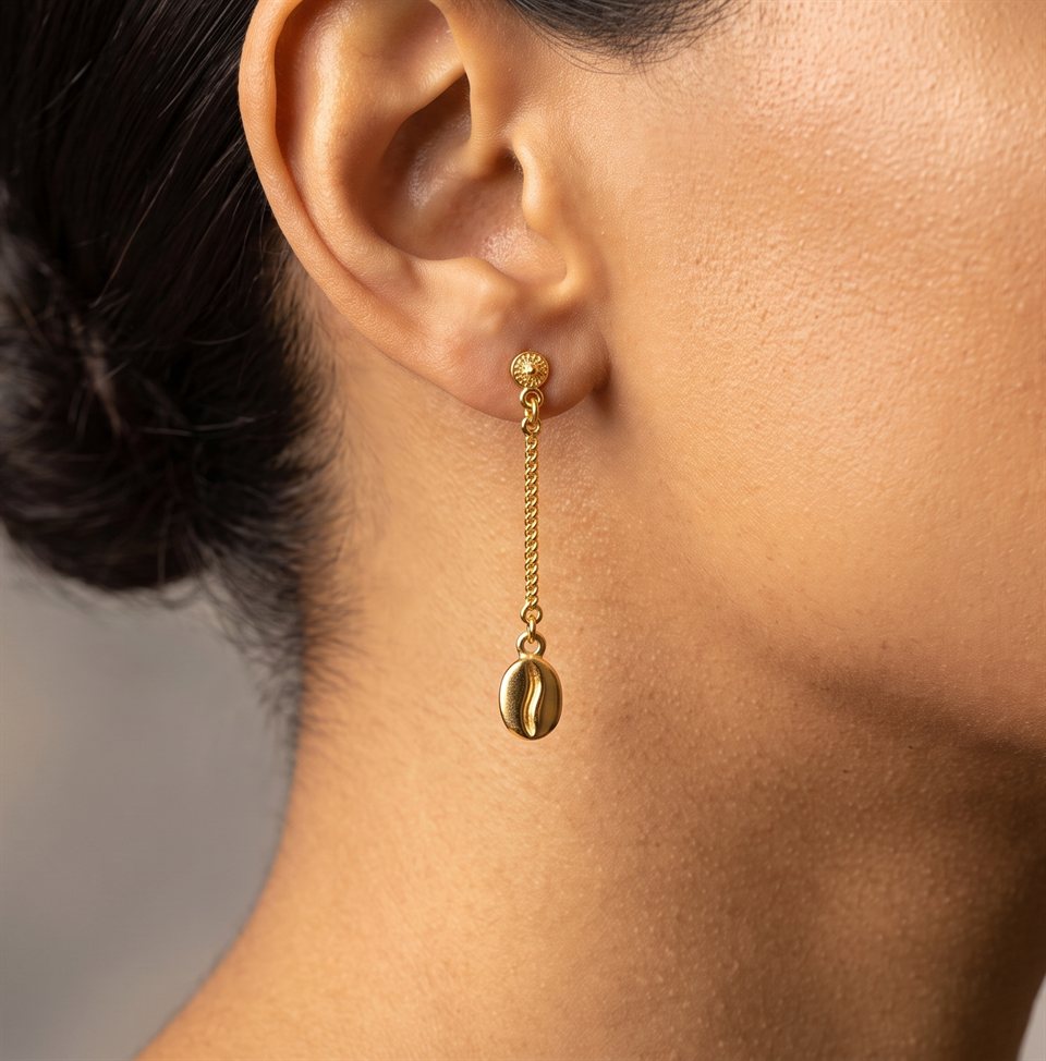 Gold coffee bean drop earring on a fine chain, worn