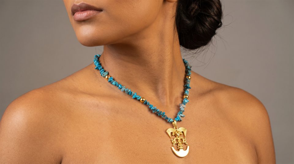 Model wearing turquoise chip beads with a Cauca bird-beaked man in gold