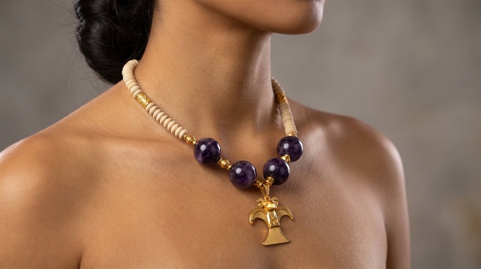 Model wearing cream beads and amethyst nuggets with a Diquís eagle in gold