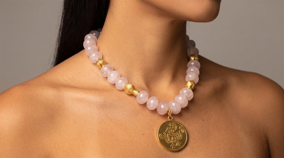 Faceted rose quartz necklace with a gold medallion engraved with a frog shaman