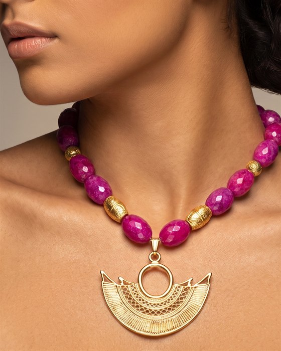 Fuchsia agate necklace with a gold filigree crescent pendant, worn