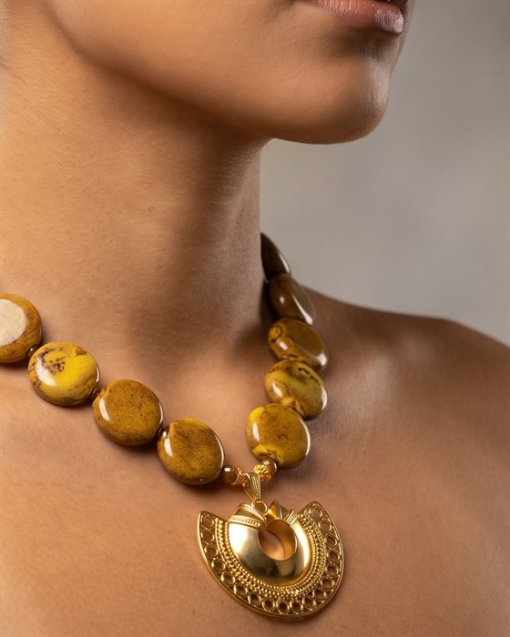 Mustard jasper disc necklace with a gold crescent nariguera, worn